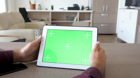 Holding a Digital Tablet PC in Hands with Green Screen Chroma Mock Up alt