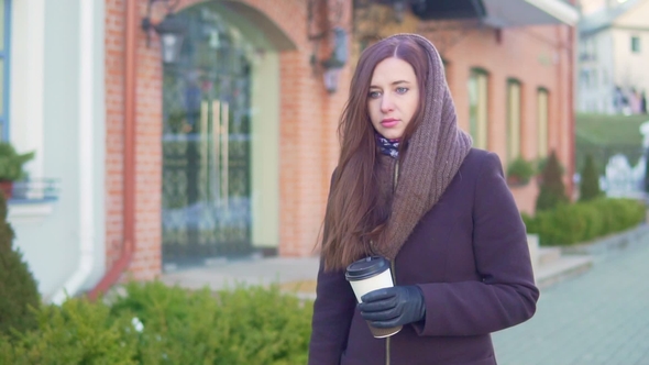 Young Woman Drinking Coffee in the City