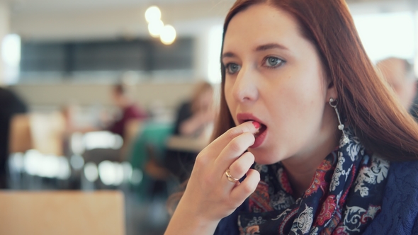 Woman Eats Fast Food in a Cafe, Stock Footage | VideoHive