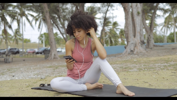 Chilling Woman with Phone on Mat in Park alt