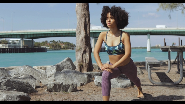 Relaxed Woman Working Out on Riverside alt