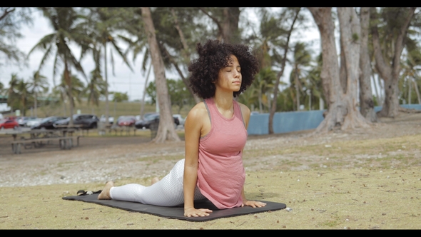 Confident Black Woman Stretching on Mat alt