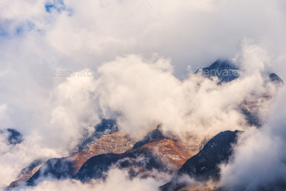 Mountains in clouds in overcast evening in Nepal - Stock Photo - Images