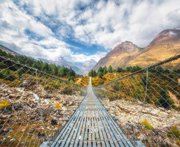 Suspension bridge and beautiful himalayan mountains - Stock Photo - Images