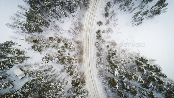Aerial view of a winter road. Winter landscape countryside. Aerial photography of snow forest. Stock Photo by gargantiopa