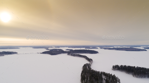 Aerial drone view of idyllic winter landscape. Evergreen snow covered forest from the top, sun rise. - Stock Photo - Images