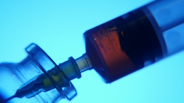 Red Liquid Is Taken Into a Syringe From a Sample Tube in a Medial Laboratory