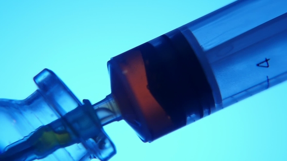 Red Fluid Is Taken Into a Syringe From a Test Tube in a Medial Laboratory