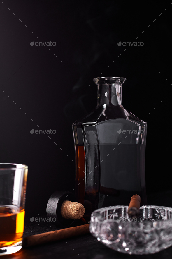 Glass of whiskey with smoking cigar. whisky, tobacco Stock Photo by bondarillia