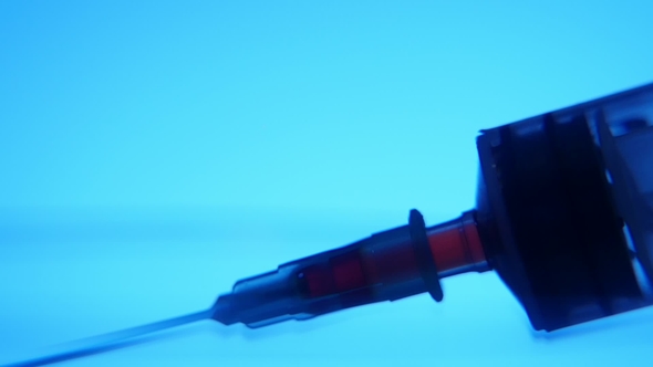 Red Liquid Is Taken Into a Syringe with a Needle in a Medial Laboratory