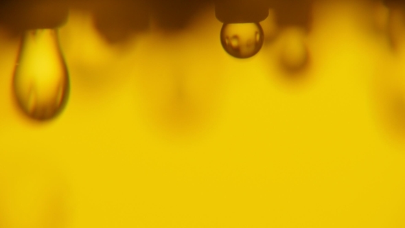 Brilliant Water Droplets Come Down From a Shower Nozzle in a Golden Bathroom