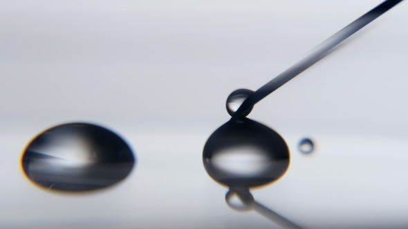 Crystaline Water Drop Increases Touching a Metallic Needle in a Scientific Lab