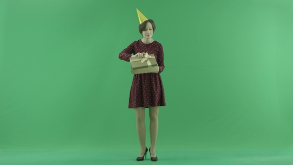 A Young Woman Is Opening Some Empty Gift Boxes on the Green Screen