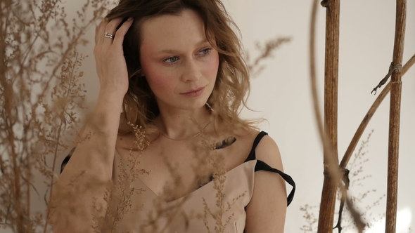 Cute Woman Is Staying Among Dead Vegetation