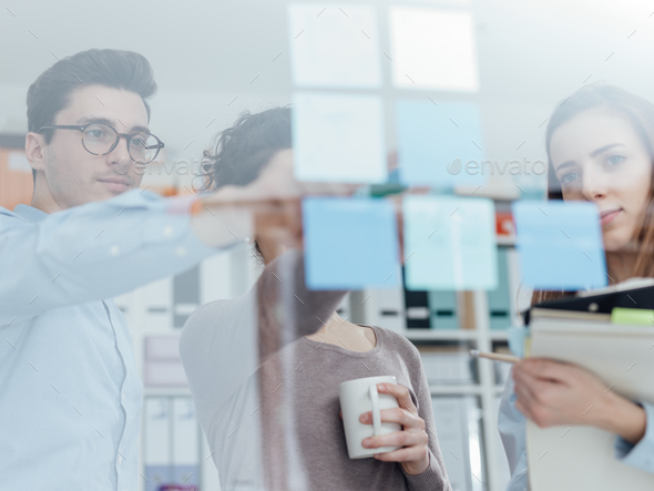 Young business team meeting in the office - Stock Photo - Images