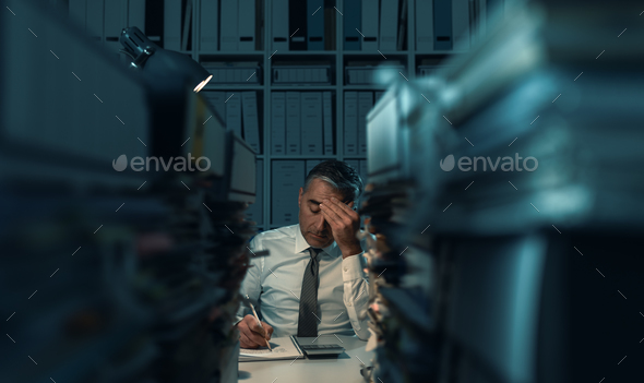 Business executive overloaded with work - Stock Photo - Images