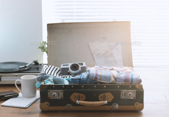 Traveler packing his suitcase before leaving - Stock Photo - Images