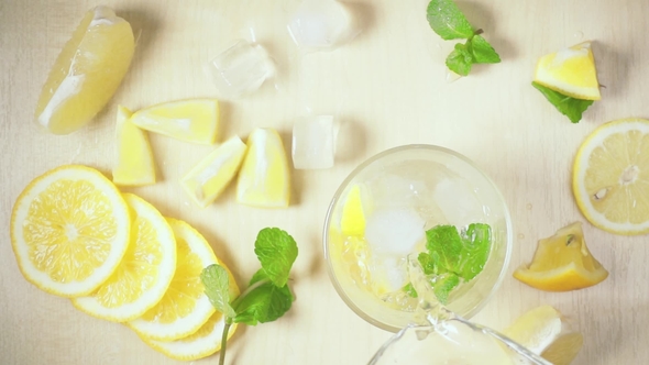 in a Glass with Ice and Mint Pour Water From the Decanter