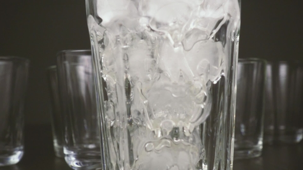 in a Glass on a Table with Ice Pour Water