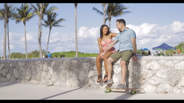 Stylish Happy Couple Relaxing on Waterfront alt