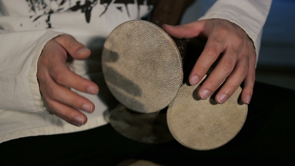 Man's Hands Drumming Out a Beat on an Arabic Percussion Drum Named Kasoureh