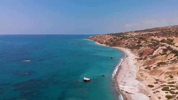 Slow aerial shot flying over the beach on the coast of Paphos Cyprus, Greece alt