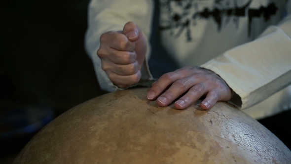 Man's Hands Drumming Out a Beat on an Arabic Percussion Drum Named Calabasse
