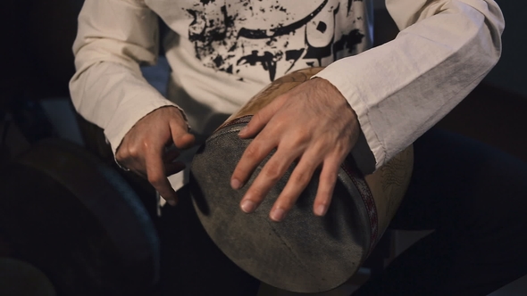 Man's Hands Drumming Out a Beat on an Arabic Percussion Drum Named Tombak