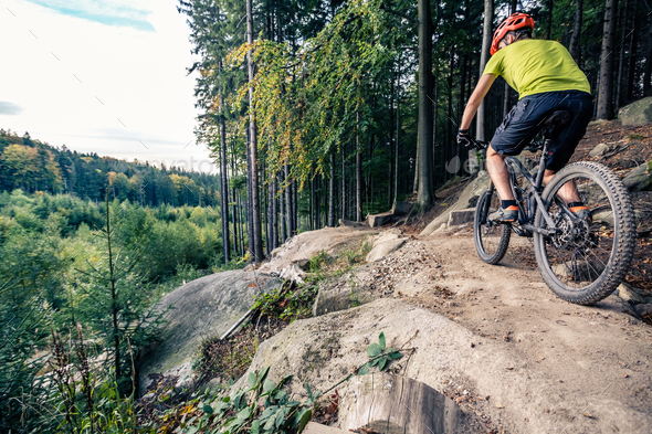 Mountain biker riding cycling in autumn forest - Stock Photo - Images