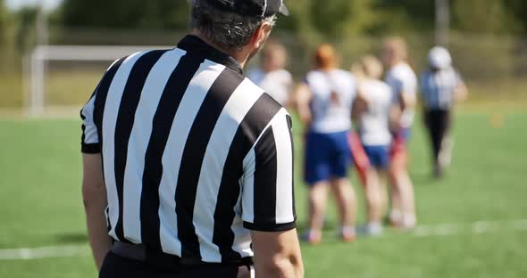 The Referee Watching the Women's Sports Team. Active Girls Discuss the Strategy of the Game with the alt