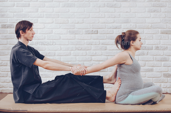 Traditional Thai Massage of a pregnant woman - Stock Photo - Images