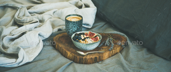 Rice coconut porridge and espresso in bed, wide composition - Stock Photo - Images