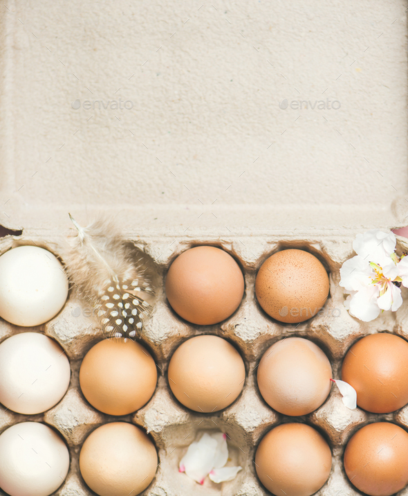 Natural colored eggs in box for Easter,vertical composition - Stock Photo - Images