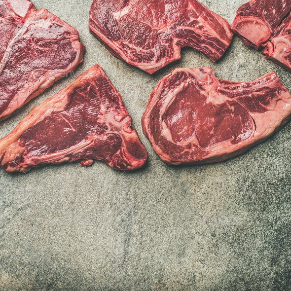 Porterhouse, t-bone and rib-eye steaks over grey background, square crop - Stock Photo - Images