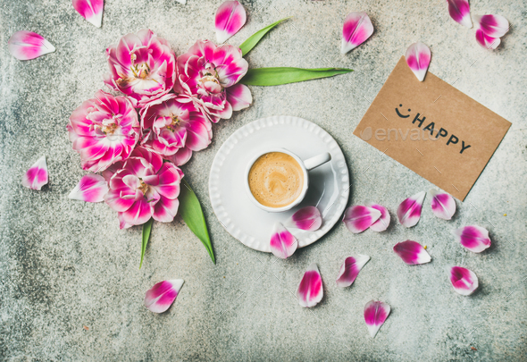Cup of coffee surrounded with pink tulip flowers, marble background - Stock Photo - Images