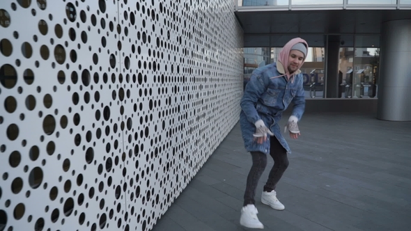 Guy Is Dancing Next To Perforated Wall