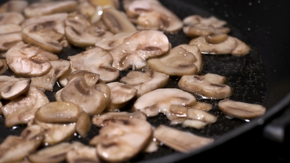 Appetizing-looking Mushrooms Are Fried in a Pan alt