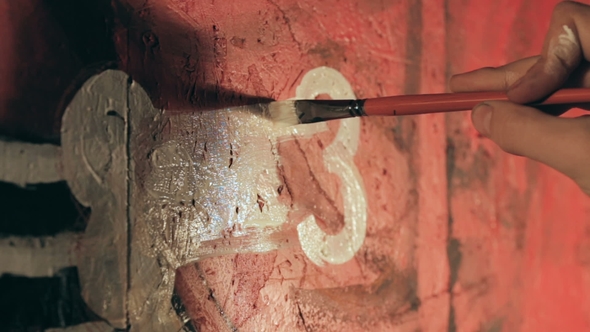 Artist Painting Graffiti in the Room. alt