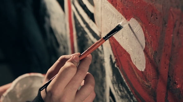 Artist Painting Graffiti in the Room.