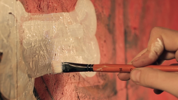 Artist Painting Graffiti in the Room. alt