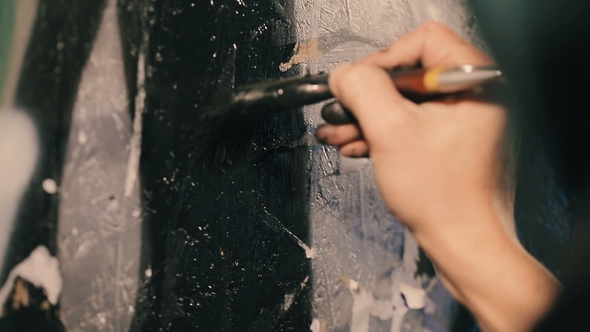 The Painter Paints the Wall in Black Color.