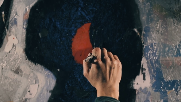 The Painter Paints the Wall in Black Color.