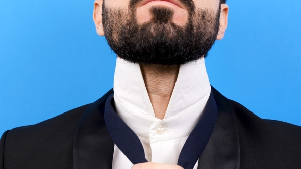 Unrecognisable Face of a Businessman in Format Suit Arranges His Tie alt