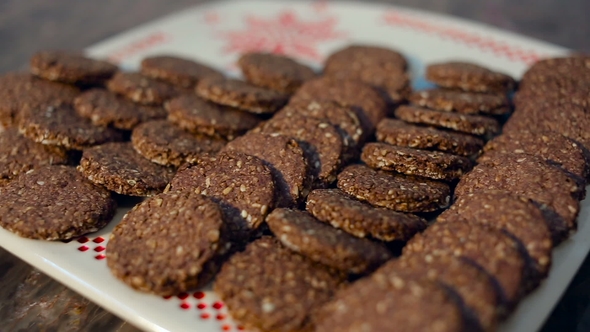 Homemade Oatmeal Cookies with Sesame Seeds on a White Plate with Ornament.