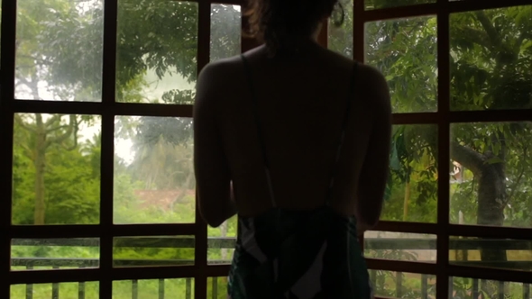 Girl Opens the Windows in a Bungalow