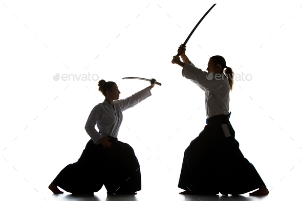 Man and woman fighting and training aikido on white studio background - Stock Photo - Images