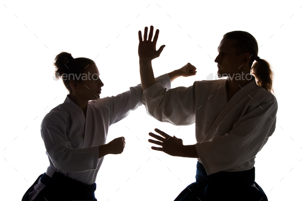 Man and woman fighting at Aikido training in martial arts school - Stock Photo - Images