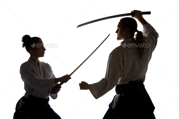Man and woman fighting and training aikido on white studio background - Stock Photo - Images