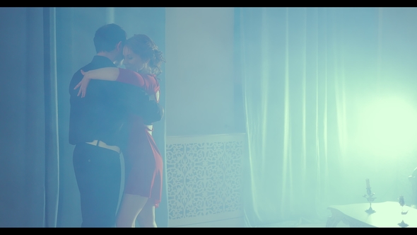 Young Couple Dancing Tango. Professional Girl in Red Dress and Man Dancing Latin alt