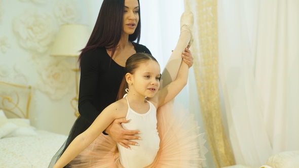 Mom Ballerina Stretches Her Little Daughter in Twine